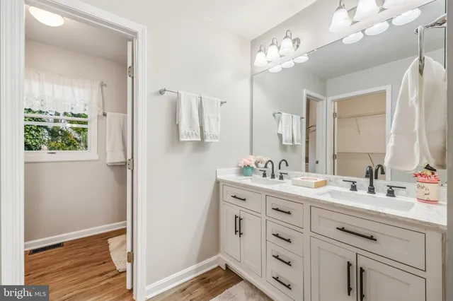 a bathroom with a shower a sink and a mirror