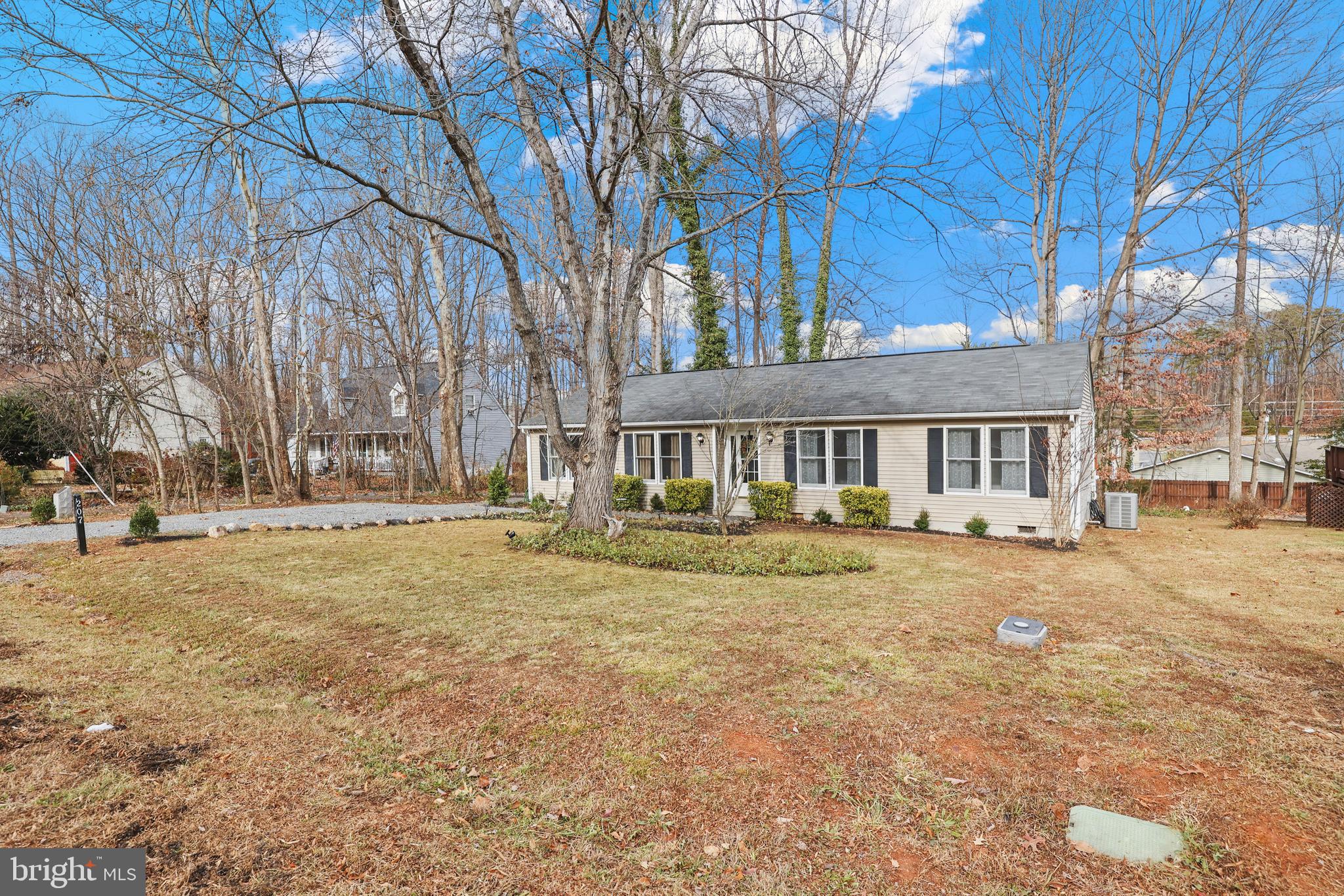 207 Spotswood Road Locust Grove, VA 22508 - Photo 3 of 58 a front view of a house with a yard and trees