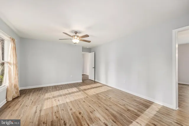 wooden floor in an empty room with a window