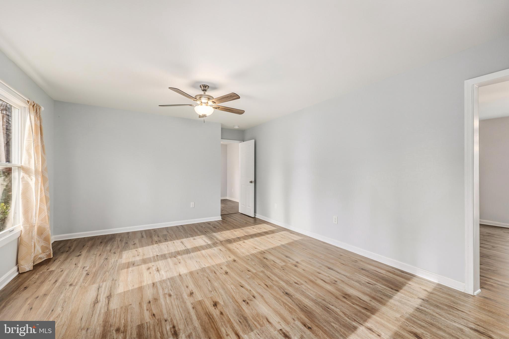 207 Spotswood Road Locust Grove, VA 22508 - Photo 4 of 58 wooden floor in an empty room with a window