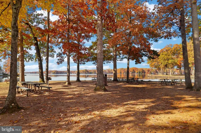 an aerial view of a house with a swimming pool and outdoor seating