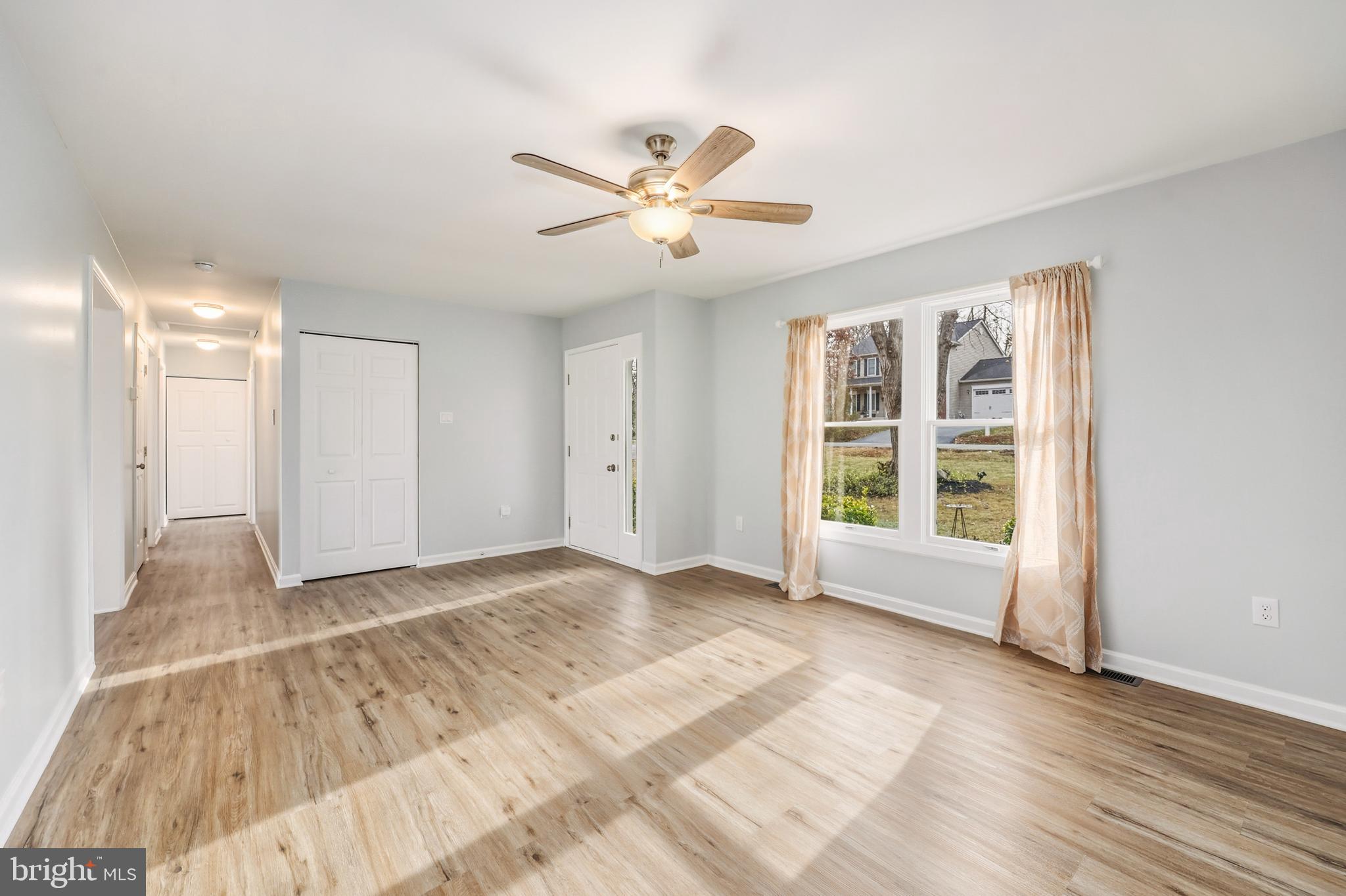 207 Spotswood Road Locust Grove, VA 22508 - Photo 7 of 58 a view of an empty room with a window and wooden floor