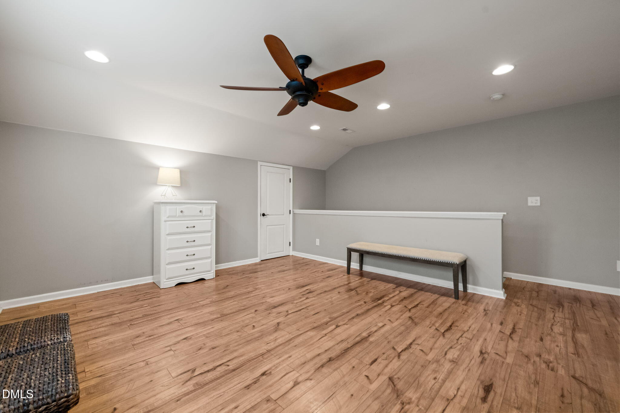 1716 Main Divide Drive Wake Forest, NC 27587 - Photo 32 of 45 a view of an empty room with wooden floor and a ceiling fan