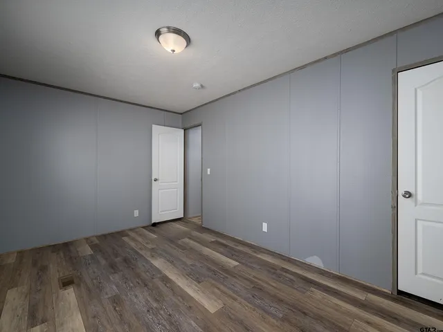 a view of room with wooden floor