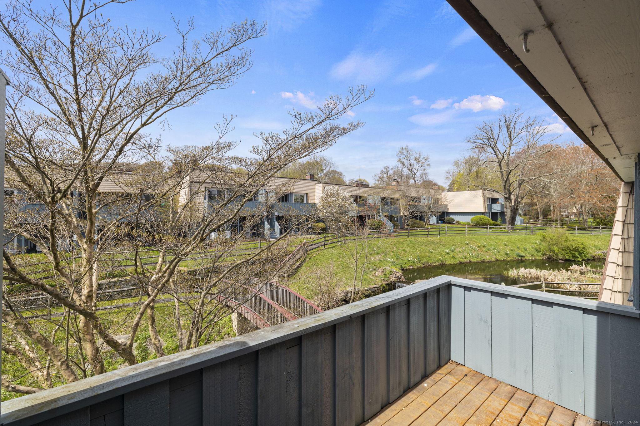 1153 Stratfield Road, Unit 1153 Fairfield, CT 06825 - Photo 12 of 18 Private back deck overlooking waterfall and pond