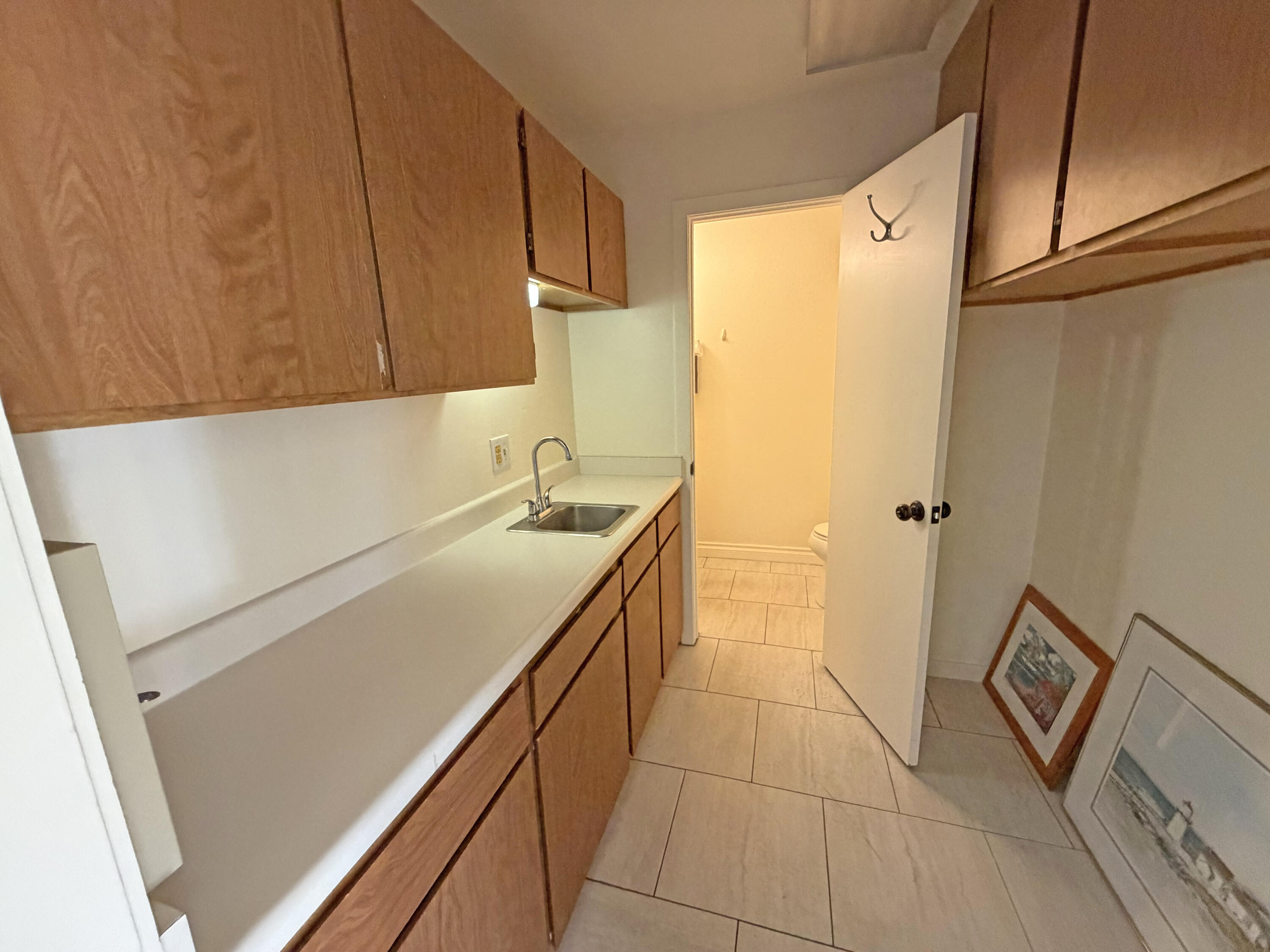 315 Meigs Road Santa Barbara, CA 93109 - Photo 13 of 14 a kitchen with a sink a refrigerator and cabinets