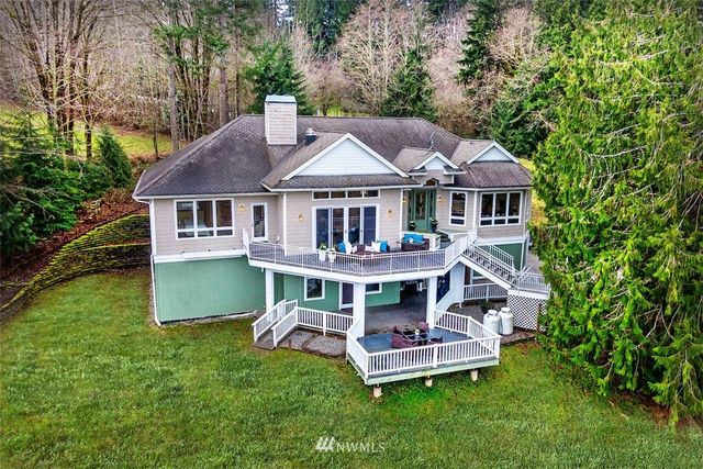 an aerial view of a house with a yard table and chairs