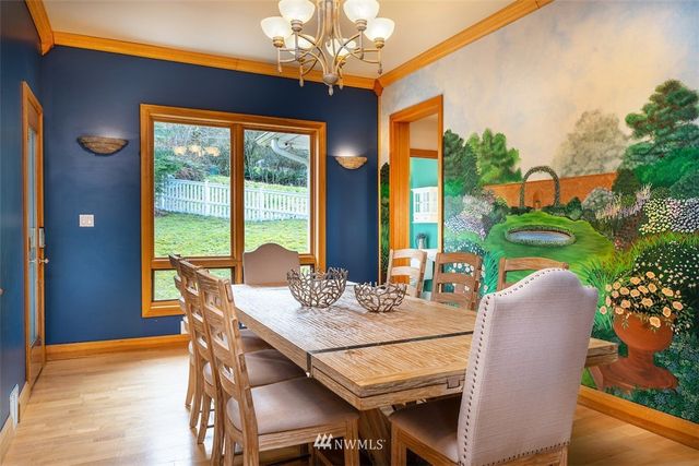 a view of a dining room with furniture a chandelier and wooden floor