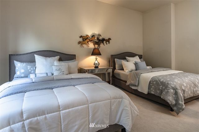 a bedroom with bed and a chandelier