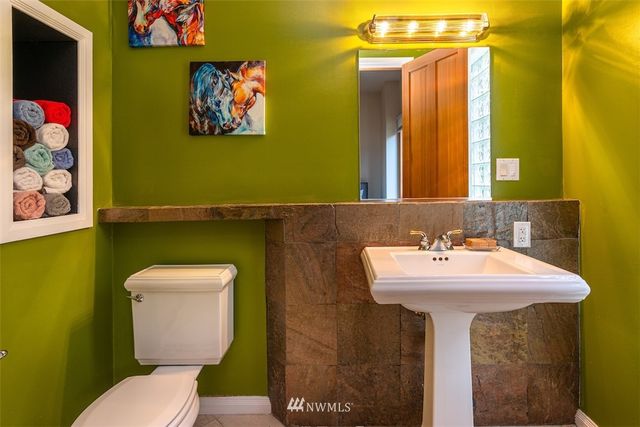 a bathroom with a toilet sink and mirror