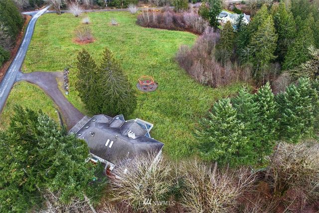 a view of a house with cars parked
