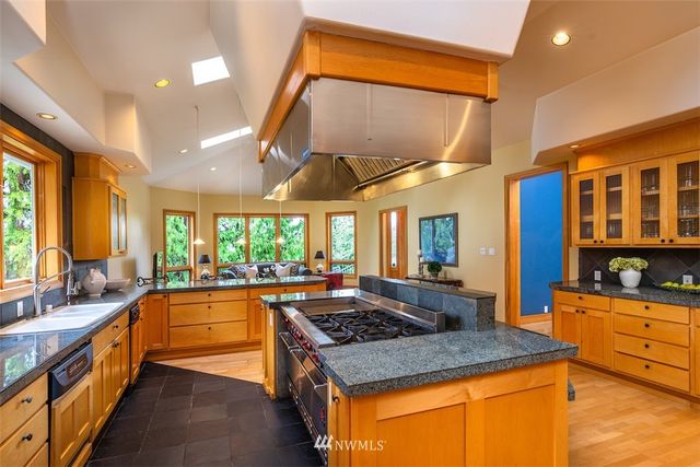 a kitchen with stainless steel appliances granite countertop sink stove and cabinets