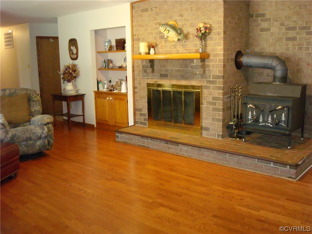 12803 Spring Run Road Chesterfield, VA 23832 - Photo 11 of 40 a living room with furniture a fireplace and a flat screen tv