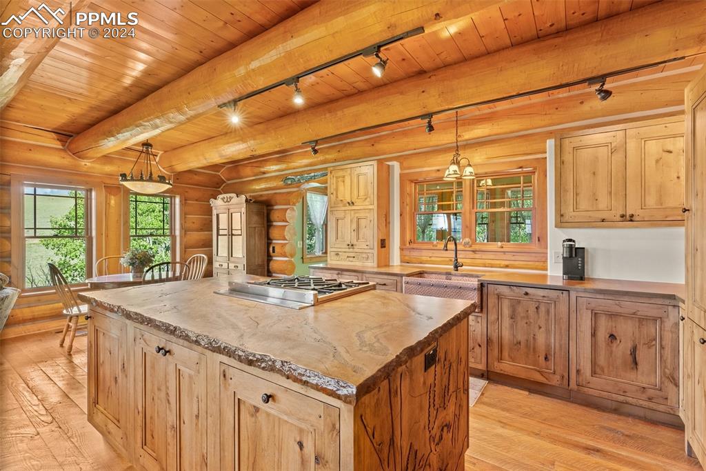 626 Stacker Drive Hartsel, CO 80449 - Photo 37 of 50 a kitchen with granite countertop a sink and wooden cabinets