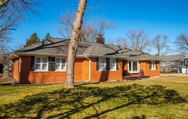 a front view of a house with a yard table and chairs