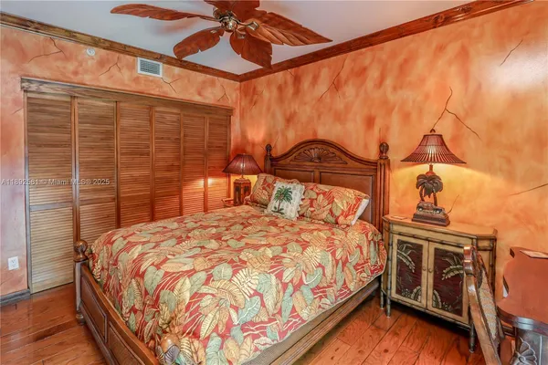 a bedroom with a bed and a television