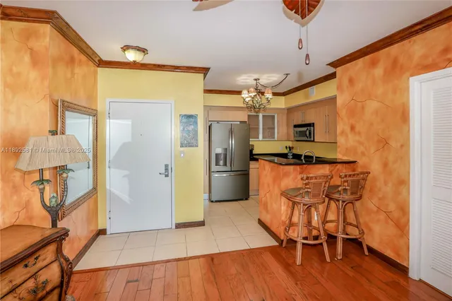 a kitchen with granite countertop a refrigerator and a stove top oven