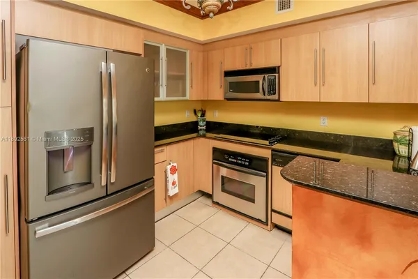 a kitchen with a sink a stove and cabinets