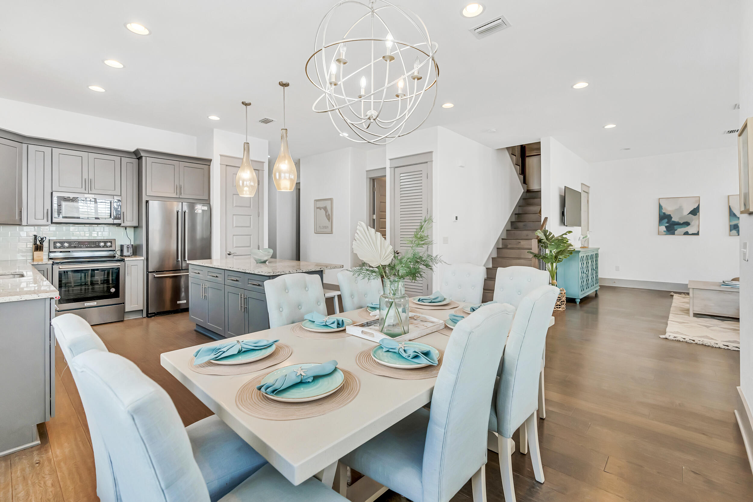 70 Ruth Street Miramar Beach, FL 32550 - Photo 15 of 50 a view of a dining room with furniture a kitchen and chandelier