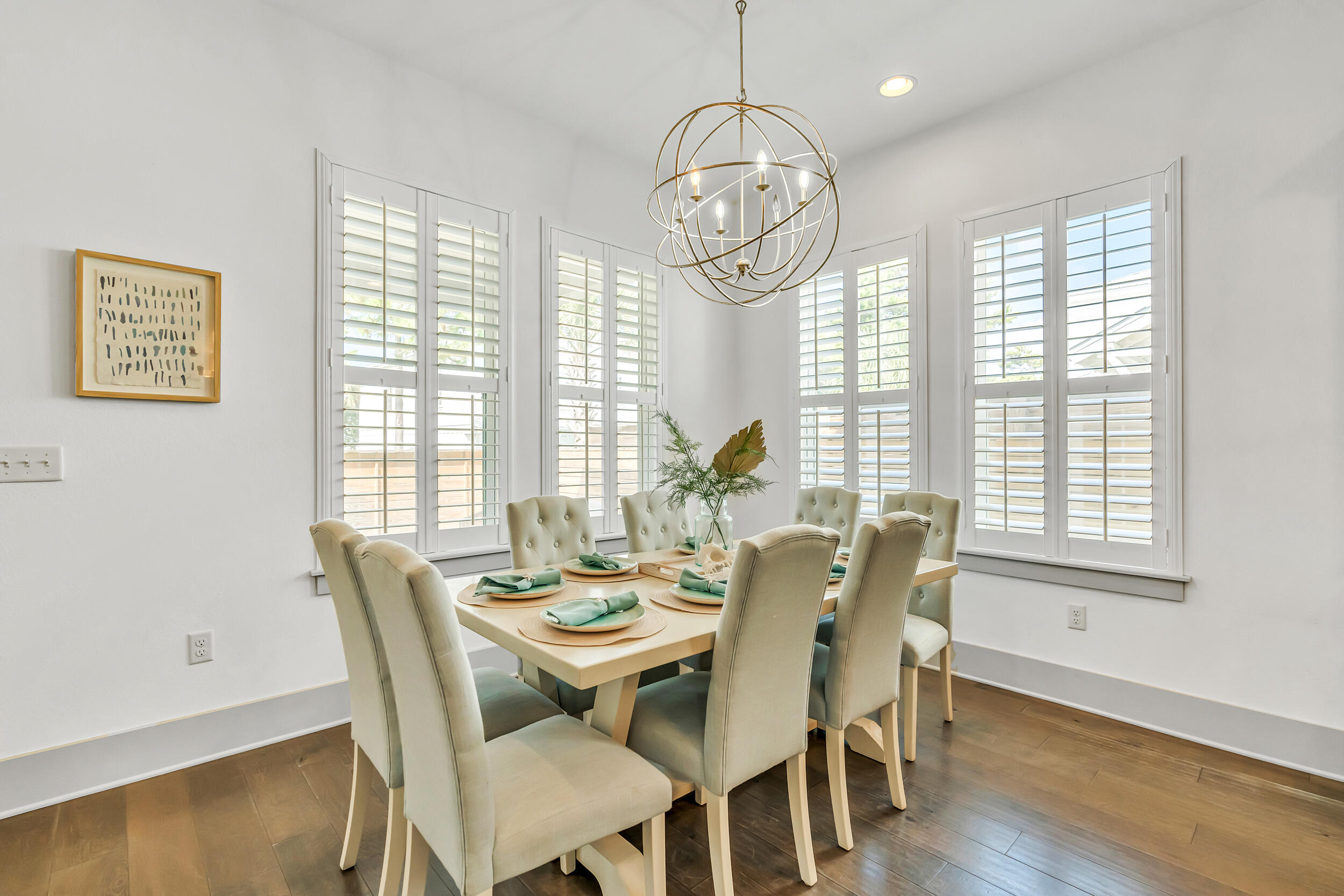 70 Ruth Street Miramar Beach, FL 32550 - Photo 16 of 50 a view of a dining room with furniture wooden floor and chandelier