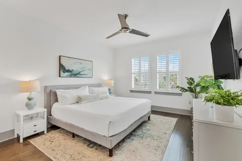 a bedroom with a large bed and a potted plant
