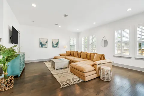 a living room with furniture and a potted plant