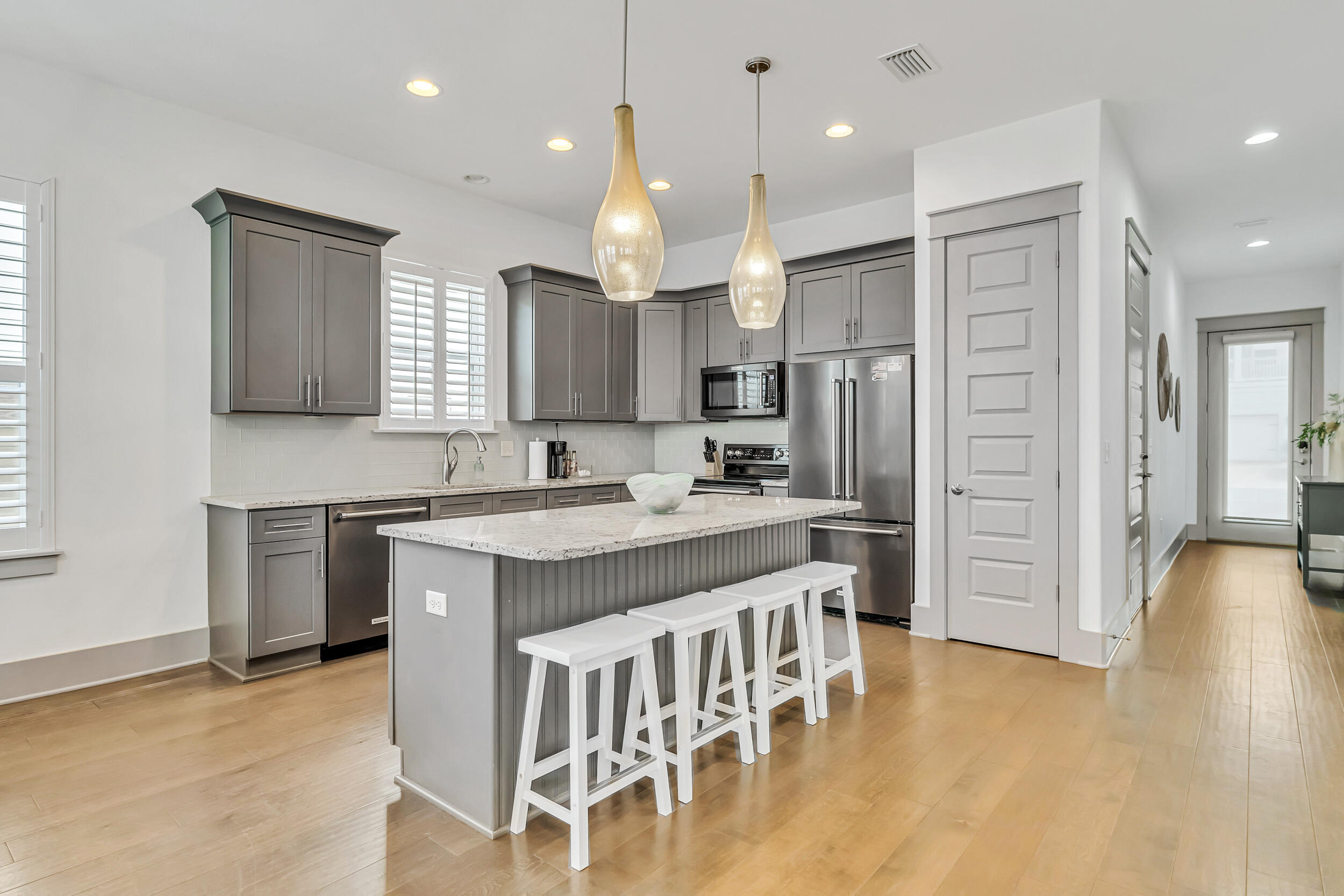 70 Ruth Street Miramar Beach, FL 32550 - Photo 10 of 50 a kitchen with stainless steel appliances granite countertop a sink a stove a refrigerator and a island