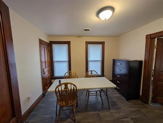 a view of a livingroom with furniture window and wooden floor