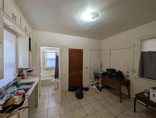 a living room with furniture gym equipment and a flat screen tv