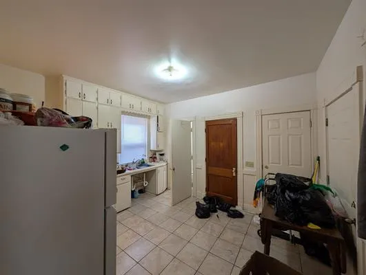 a room with furniture a air conditioner vent and a window