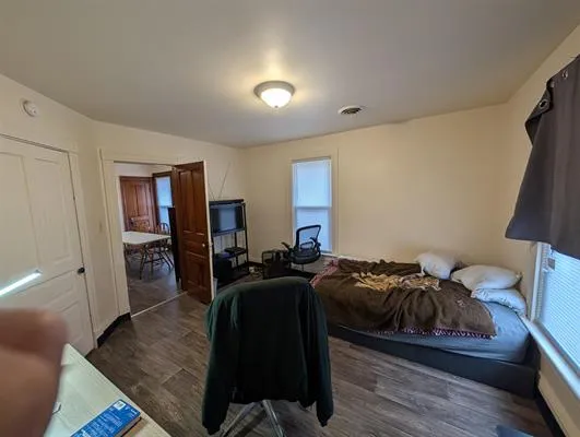 a bedroom with furniture and a wooden floor