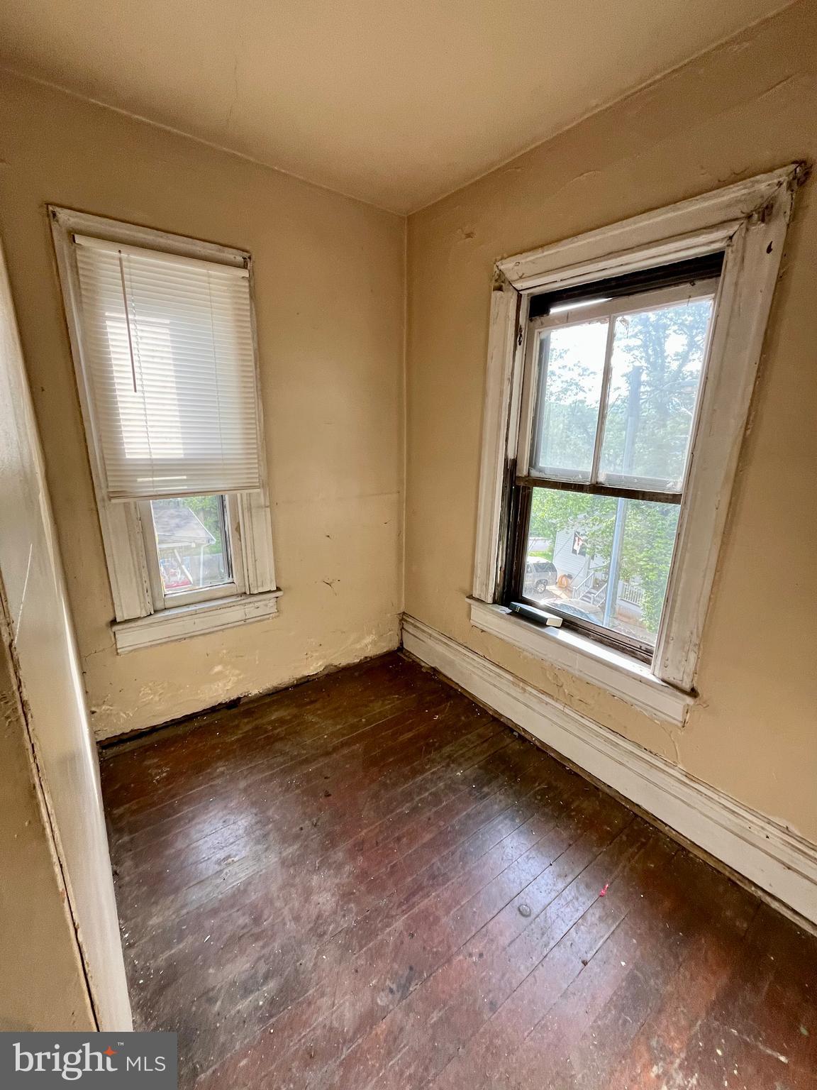 407 Carruthers Street Lexington, VA 24450 - Photo 14 of 29 an empty room with wooden floor and windows