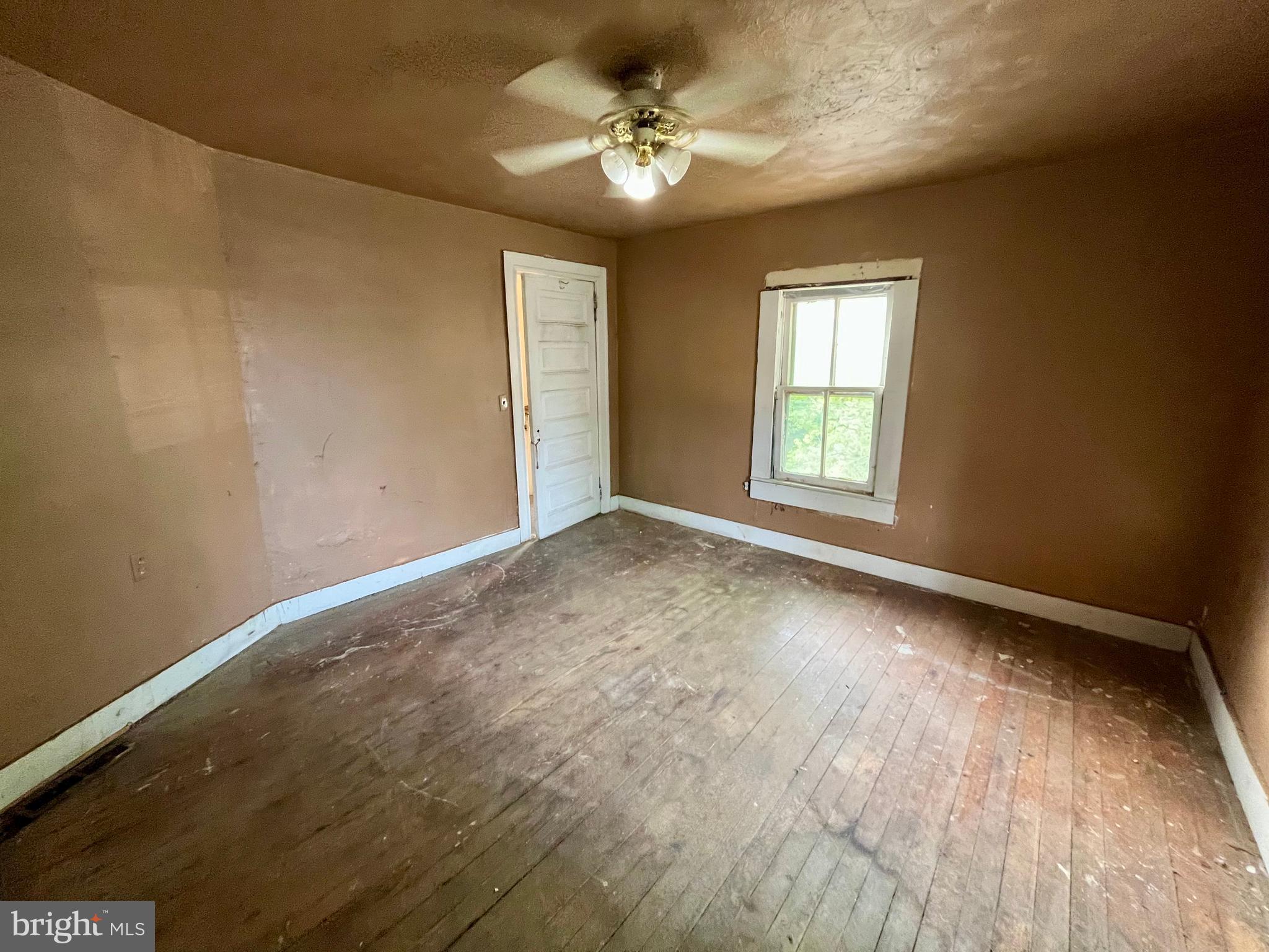 407 Carruthers Street Lexington, VA 24450 - Photo 16 of 29 wooden floor in an empty room with a window