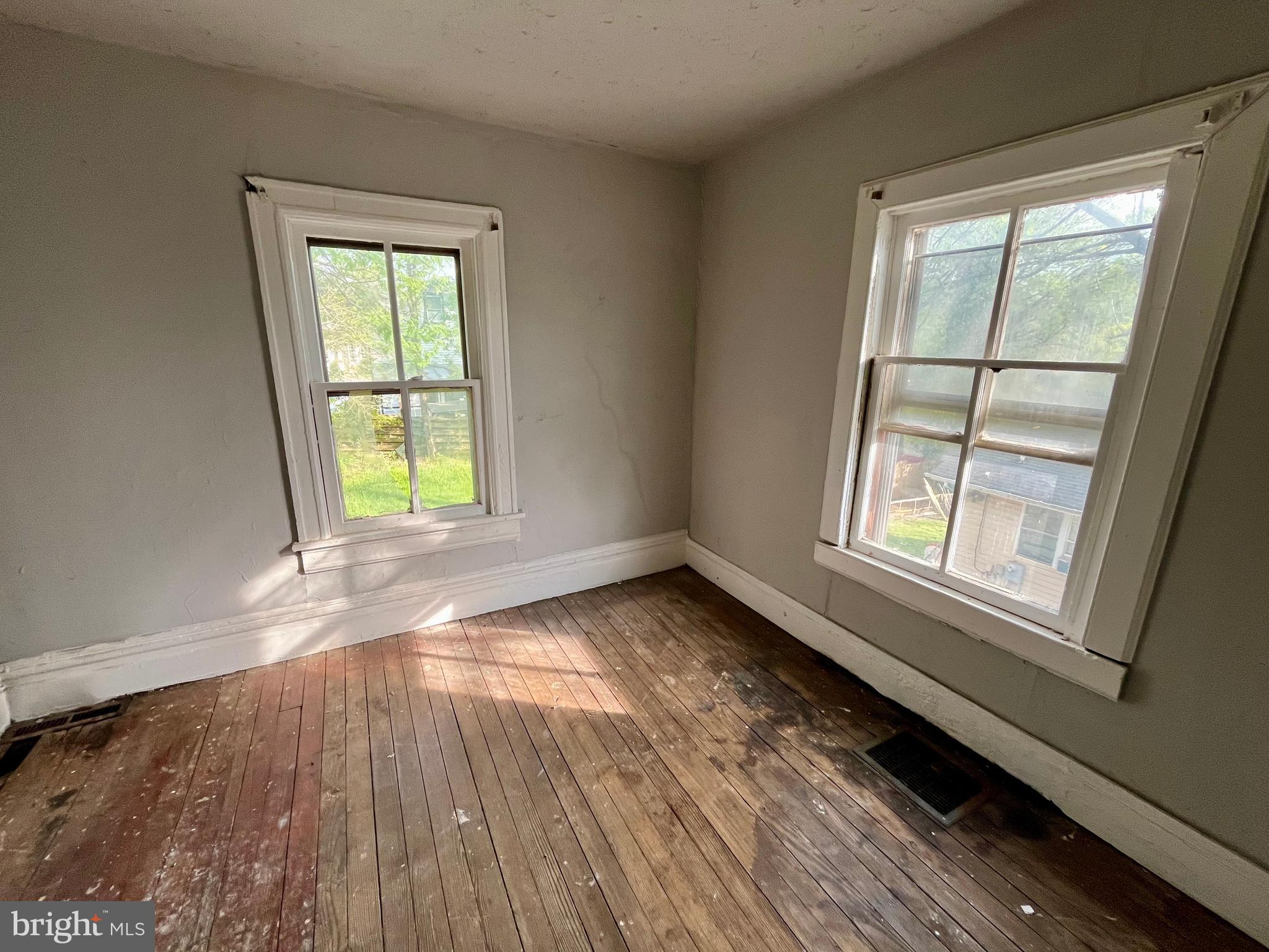407 Carruthers Street Lexington, VA 24450 - Photo 19 of 29 an empty room with wooden floor and windows