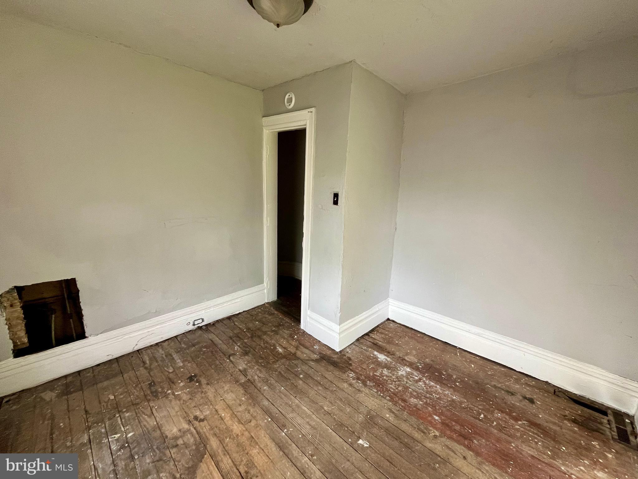 407 Carruthers Street Lexington, VA 24450 - Photo 20 of 29 a view of an empty room with wooden floor and a window