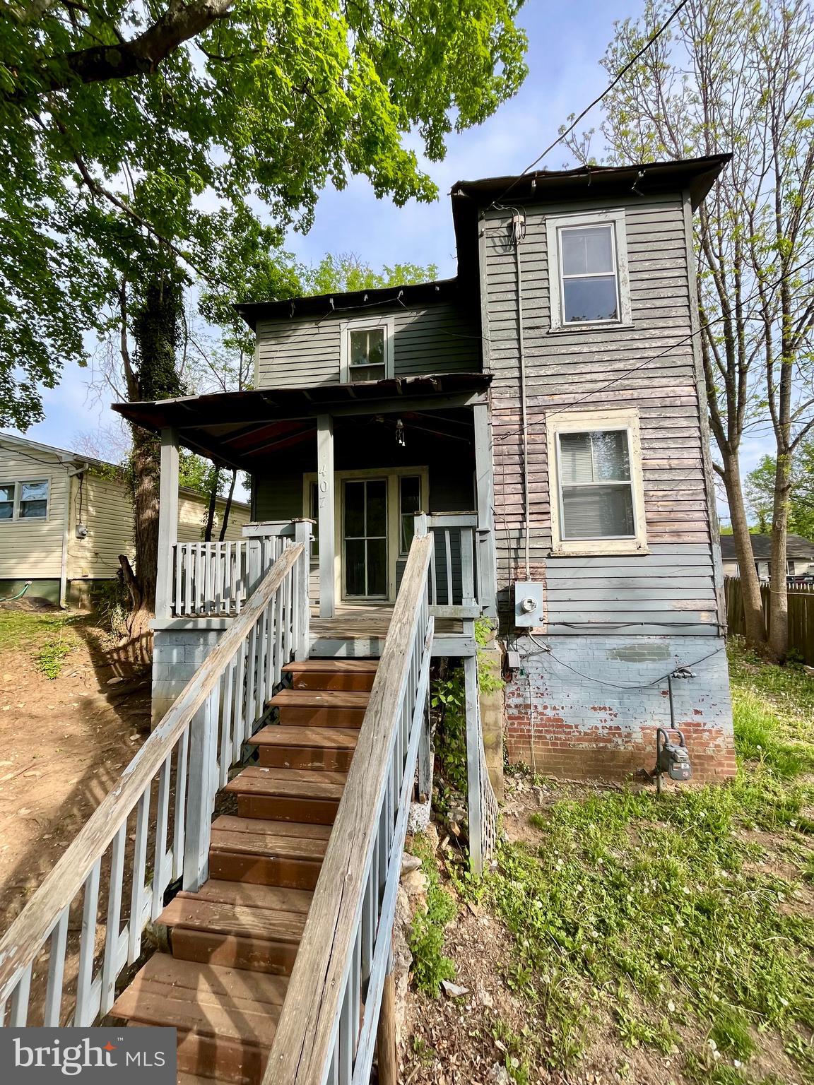 407 Carruthers Street Lexington, VA 24450 - Photo 2 of 29 a view of a house with wooden deck front of house