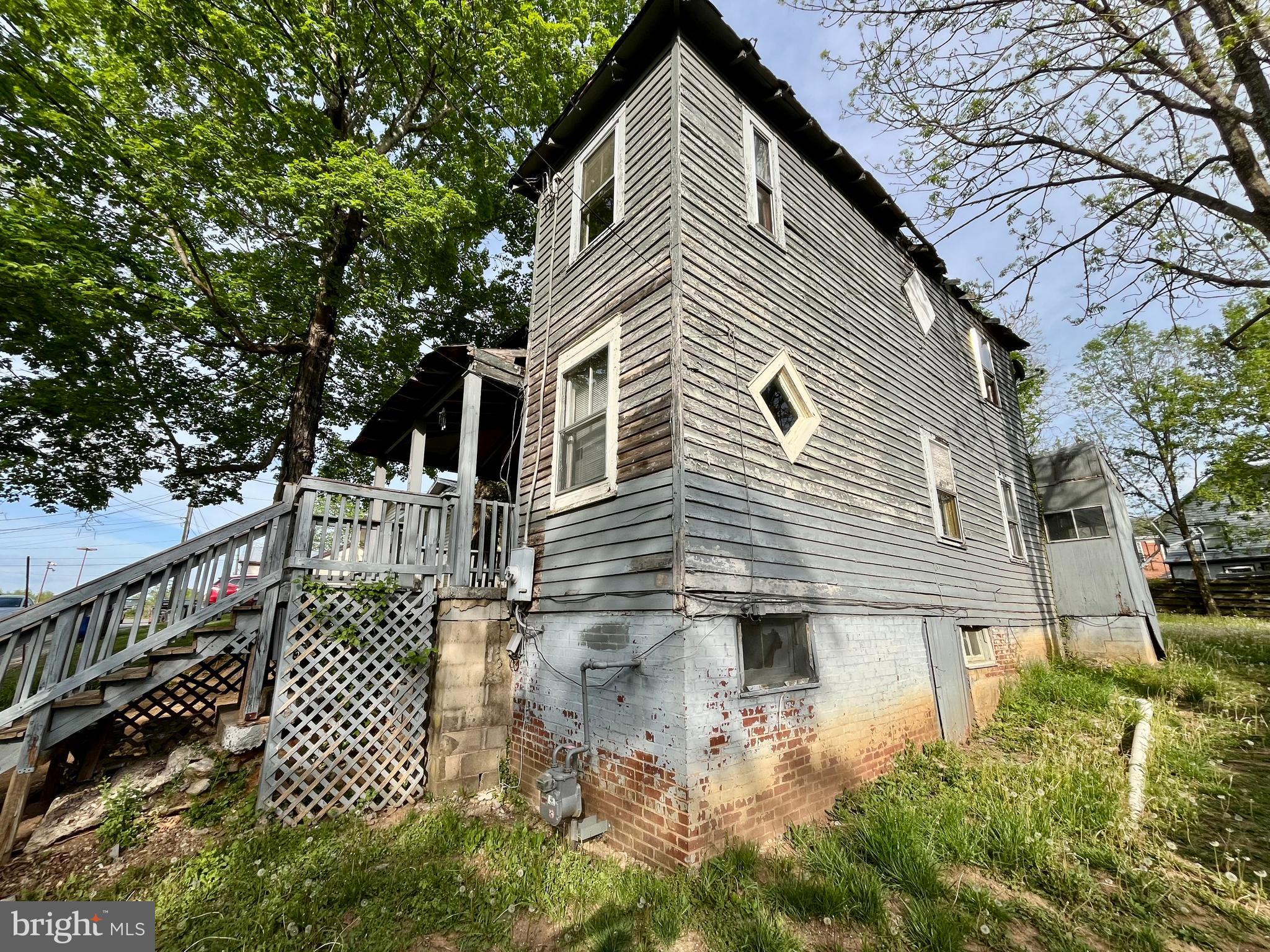 407 Carruthers Street Lexington, VA 24450 - Photo 22 of 29 a front view of a house with a garden