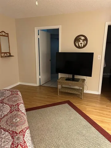 a living room with a flat screen tv and rug