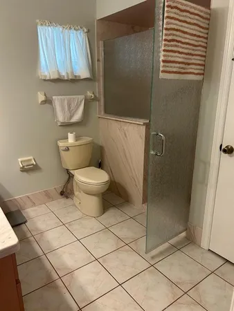 a bathroom with a toilet and a shower