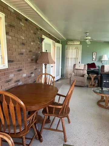 a dining room with furniture and wooden floor