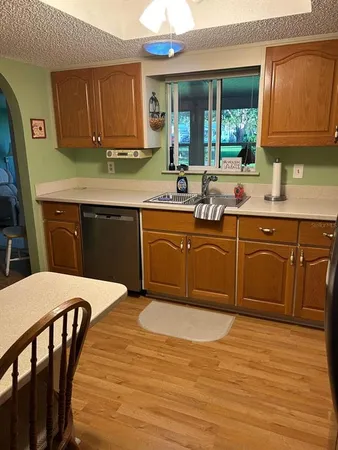 a kitchen with stainless steel appliances granite countertop a sink table and chairs