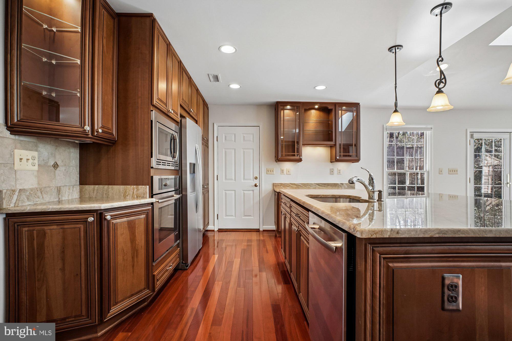 2126 Docket Lane Vienna, VA 22181 - Photo 14 of 63 a kitchen with stainless steel appliances granite countertop wooden cabinets a sink and dishwasher