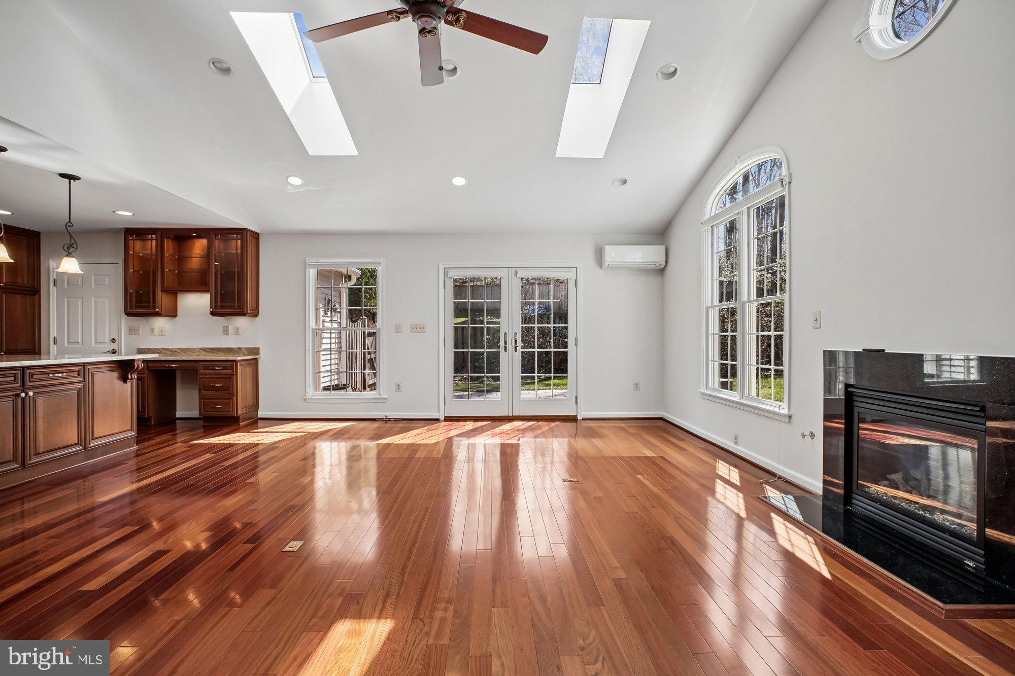 2126 Docket Lane Vienna, VA 22181 - Photo 17 of 63 a view of an empty room with wooden floor fireplace and a window