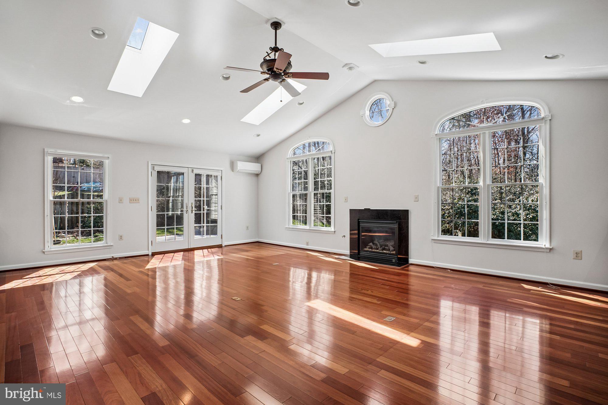 2126 Docket Lane Vienna, VA 22181 - Photo 19 of 63 a view of an empty room with wooden floor fireplace and a window