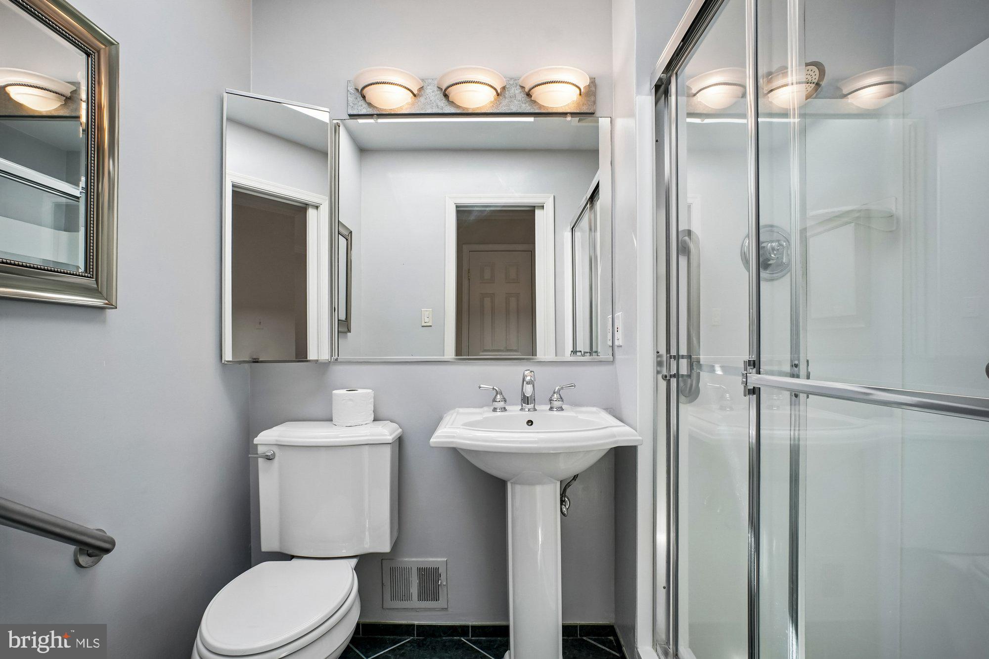 2126 Docket Lane Vienna, VA 22181 - Photo 30 of 63 a bathroom with a sink mirror toilet and shower