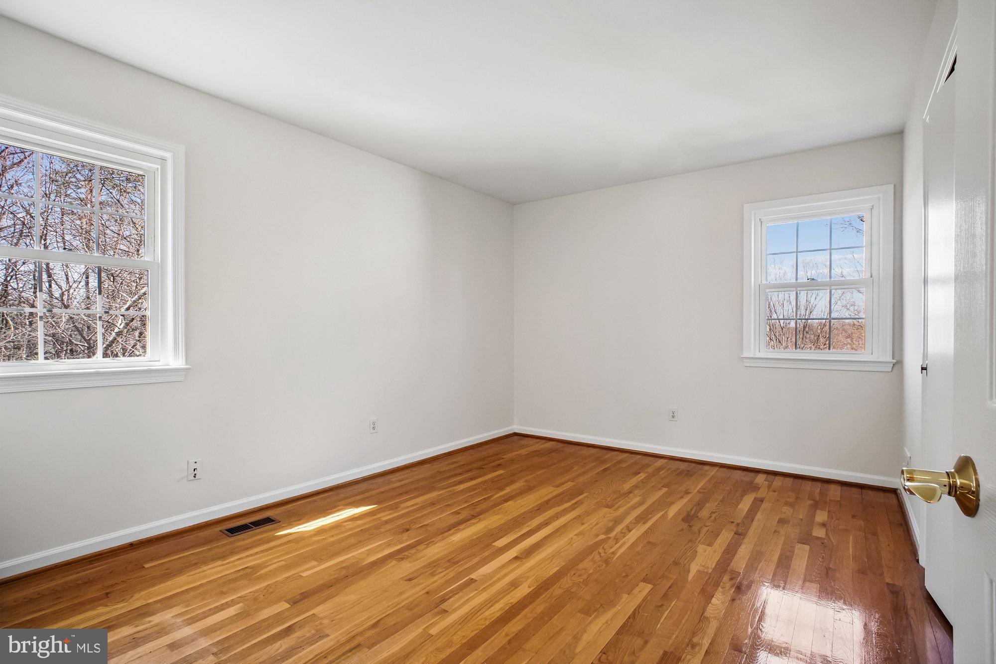 2126 Docket Lane Vienna, VA 22181 - Photo 32 of 63 a view of empty room with wooden floor and fan