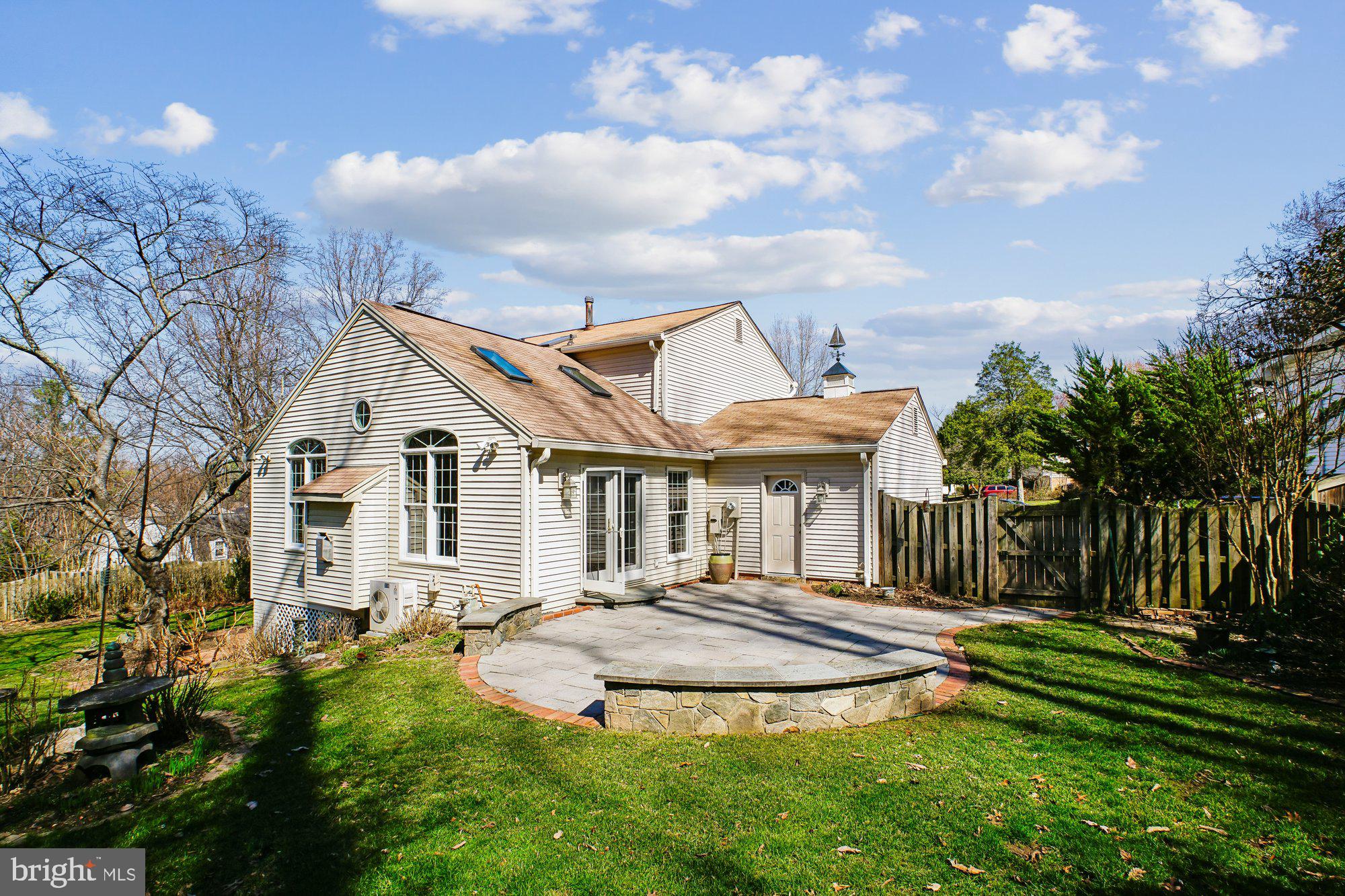 2126 Docket Lane Vienna, VA 22181 - Photo 47 of 63 a front view of a house with a yard table and chairs