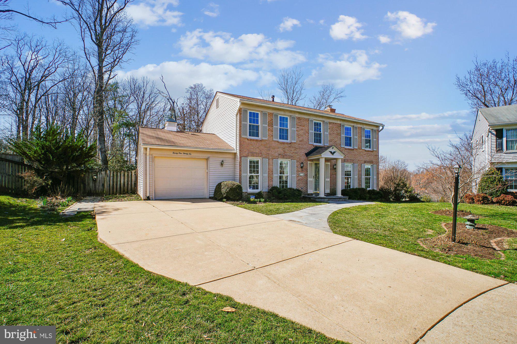 2126 Docket Lane Vienna, VA 22181 - Photo 54 of 63 a front view of a house with a yard and garage
