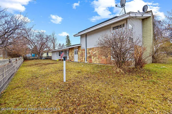 a open kitchen with stainless steel appliances kitchen island granite countertop a large window a oven and white cabinets