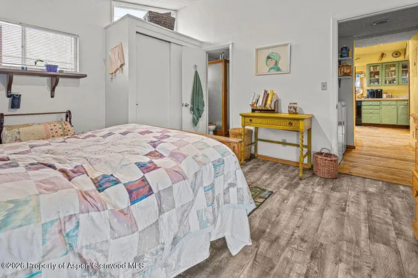 a bed room with a bed and a chair